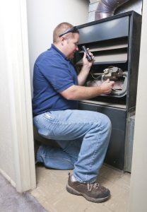 hvac-technician-inspecting-furnace