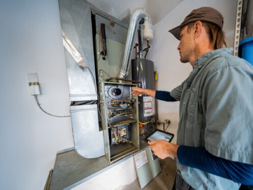 HVAC technician maintaining a furnace